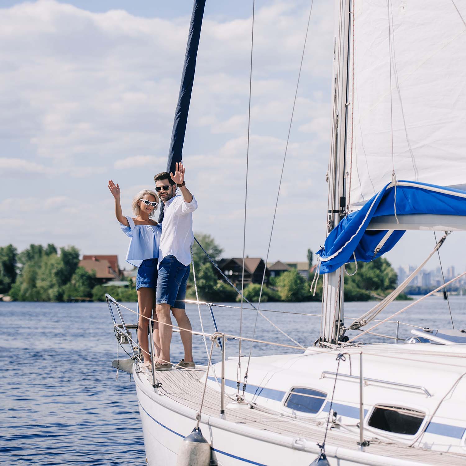 beautiful-young-couple-waving-hands-while-standing-7UG64GC.jpg