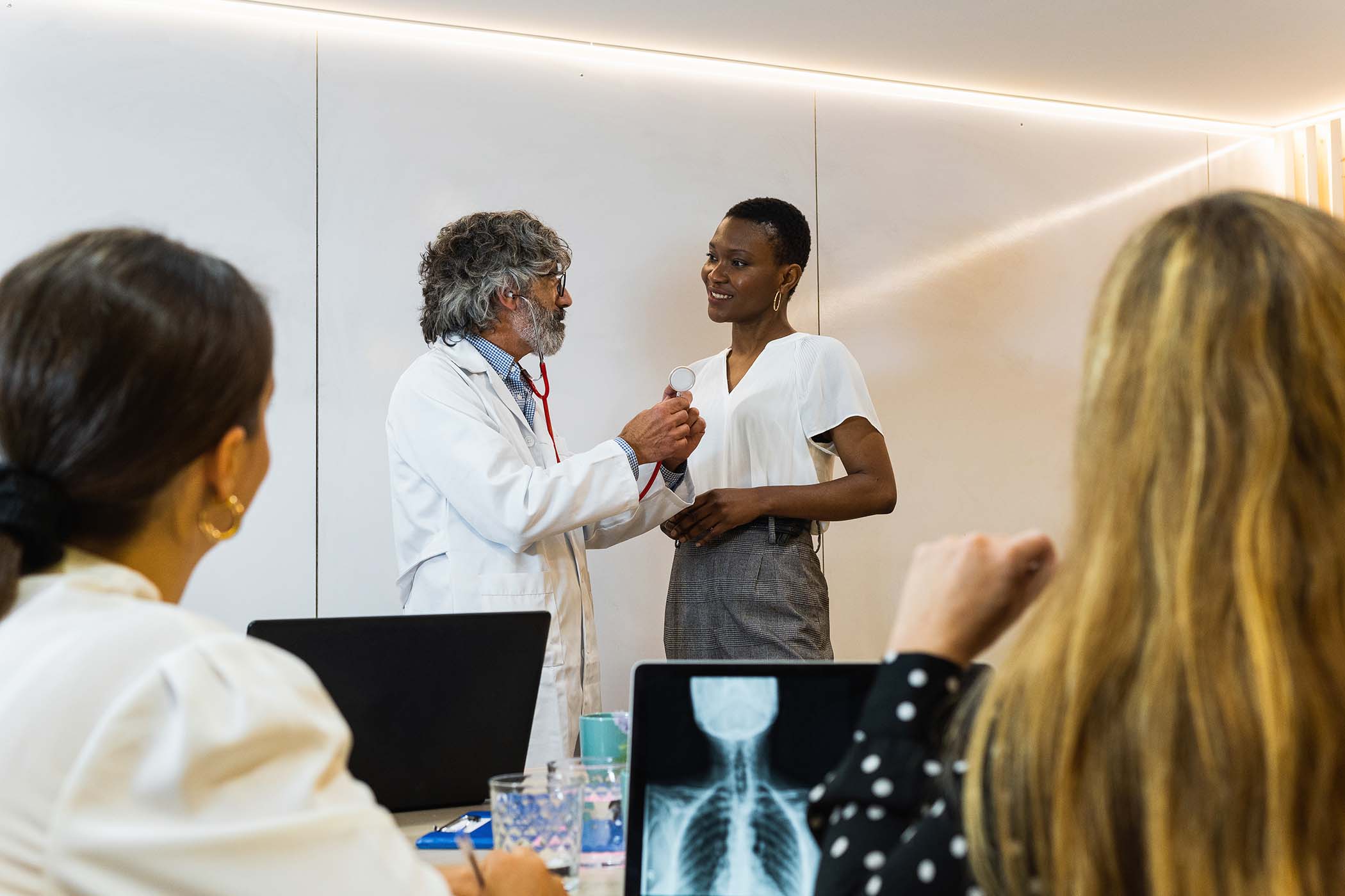 group-of-doctors-examining-patient-in-hospital-FLZMPMB.jpg
