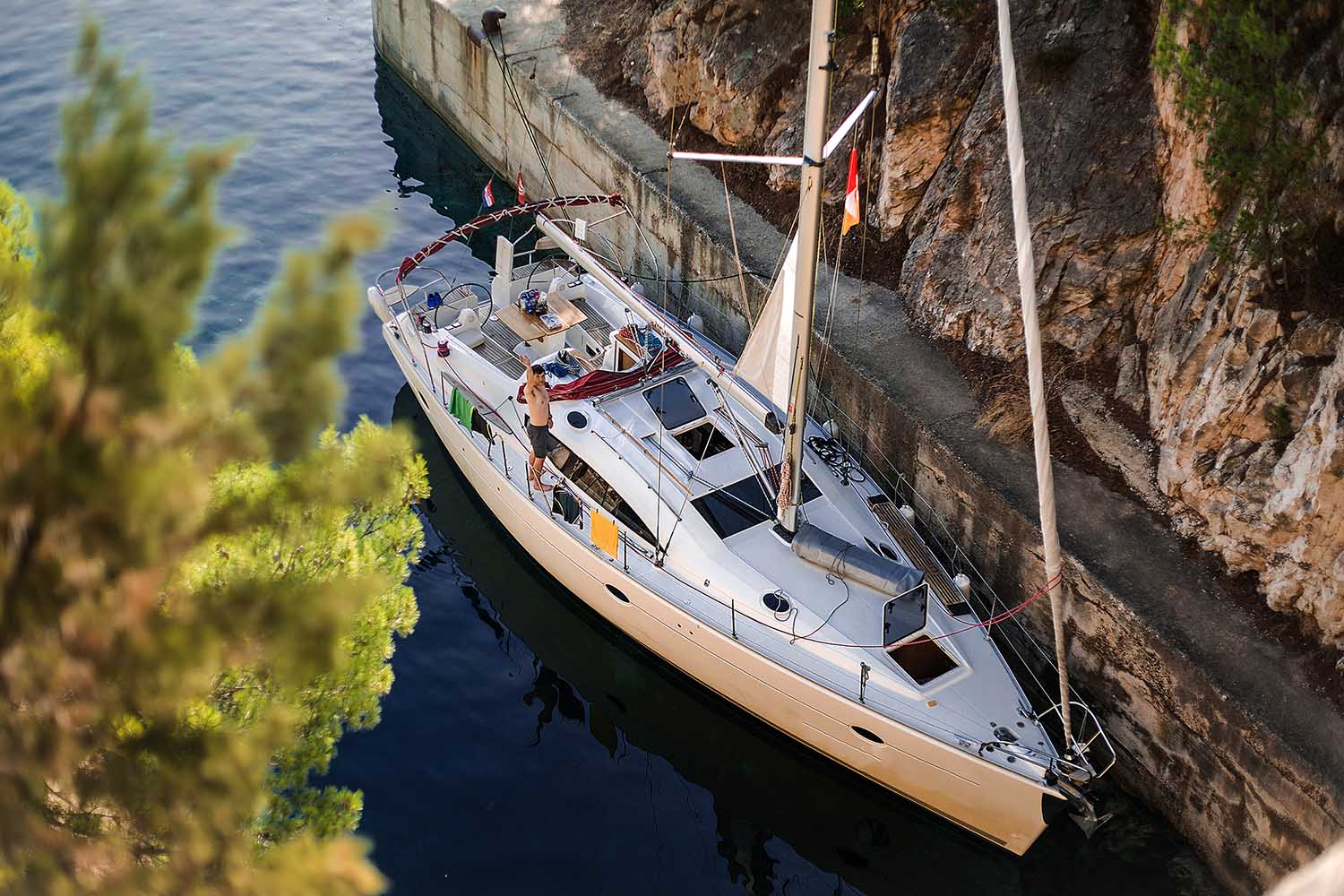 high-angle-portrait-of-man-waving-from-yacht-croa-AUHJ6KW.jpg