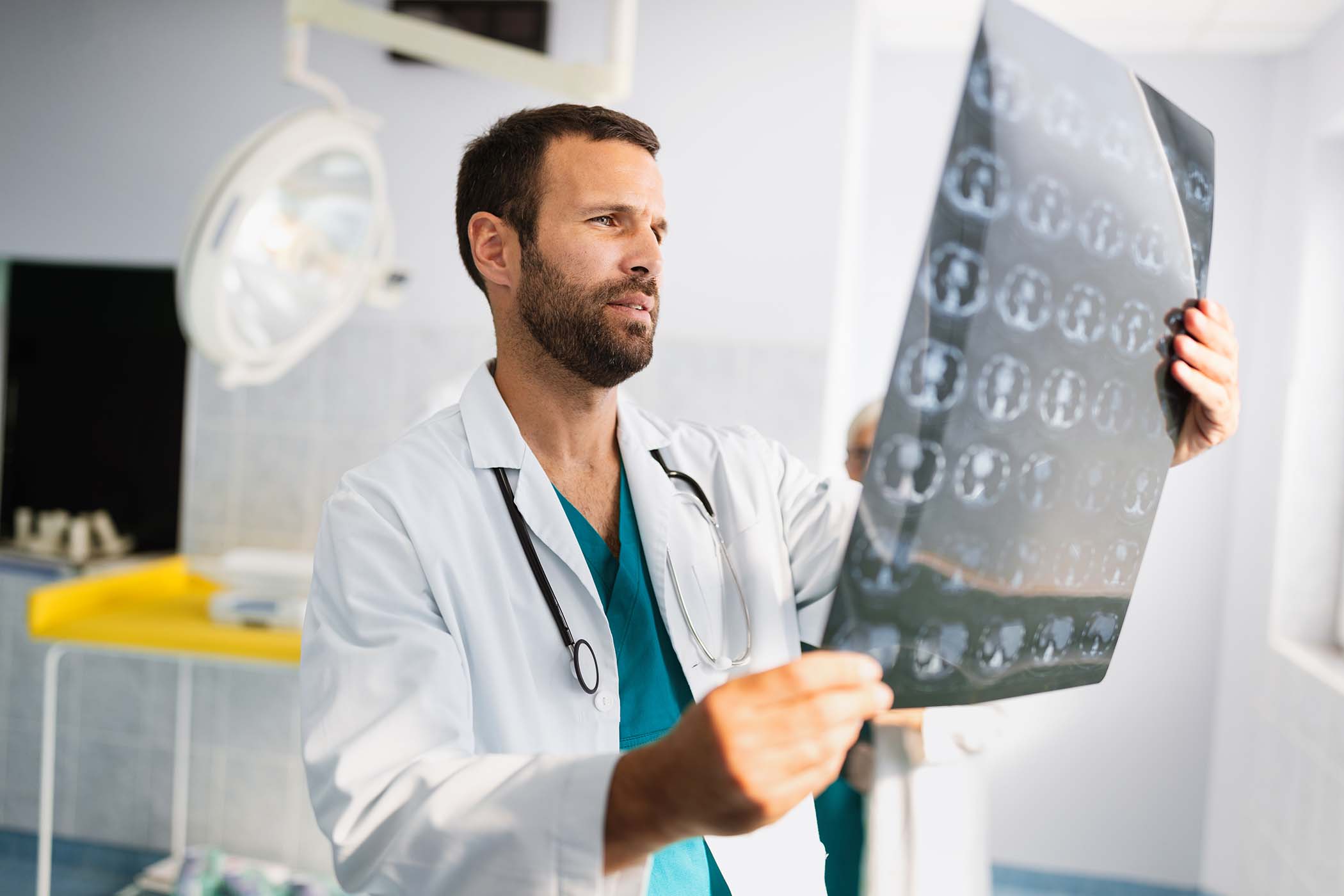 portrait-of-young-doctor-checking-x-ray-in-hospita-7HYYJ6T.jpg